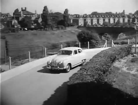 Heathfield Square alongside the railway running between Earlsfield and Clapham Junction with the rear of properties on Windmill Road to the top right. Circa 1957