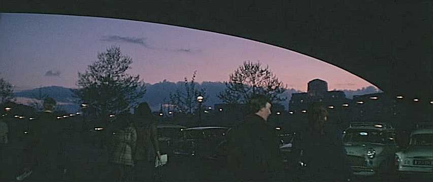 Beneath Waterloo Bridge in SE1 with the Savoy Hotel’s clock tower silhouetted in the right distance. Circa 1970