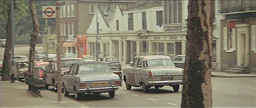 Facing south-eastward on Hampstead High Street with the King William IV public house on the corner of Perrin’s Lane to the extreme right. Circa 1970