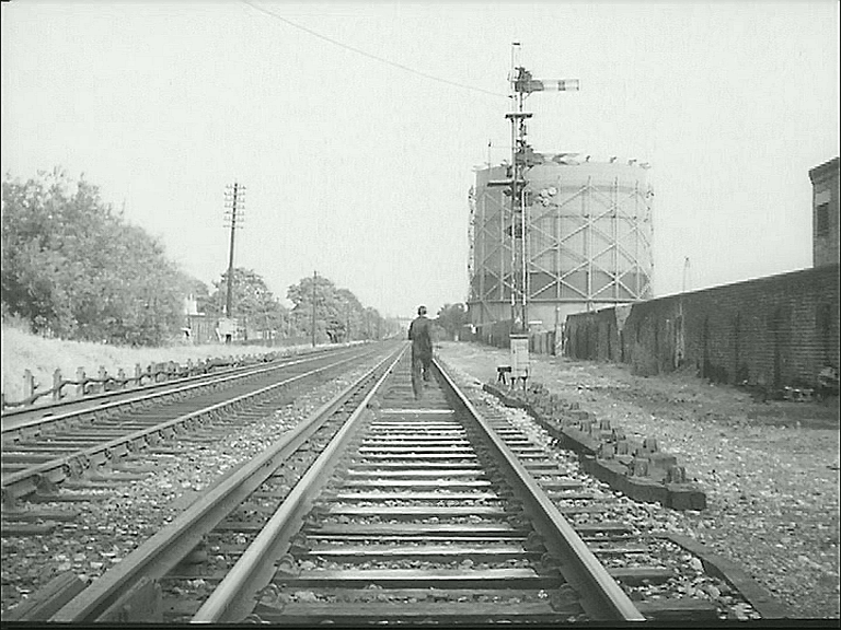 the railway line from Teddington to Hampton Wick with one of Teddington Gas Works’ holders in the right distance. Circa 1962
