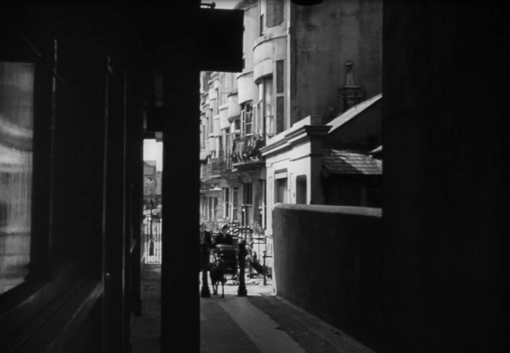 The dark building to the left of the 1947 still is the Regency Tavern, which is still there.