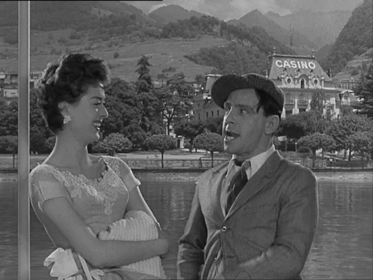 Lana Morris and Norman Wisdom on a boat on Lake Geneva. Studio with back projection.