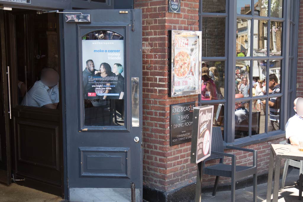 A open door and bow window at the King &Castle public house on Thames Street, Windsor
