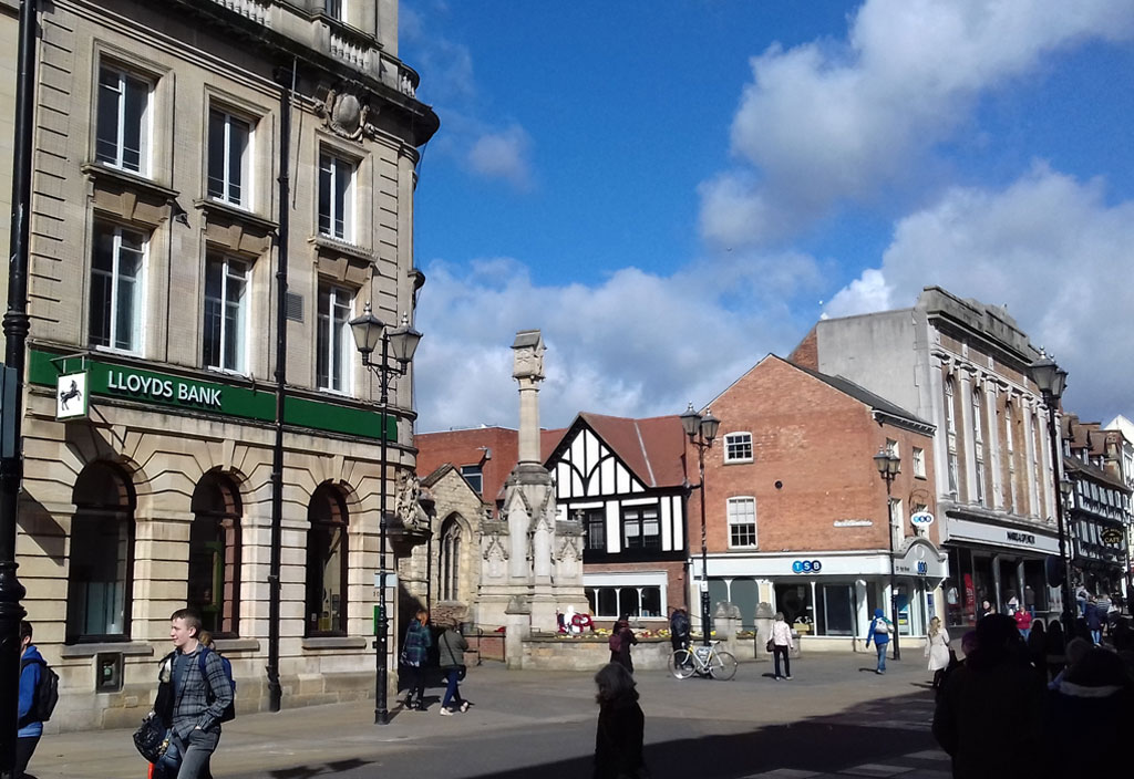High Street with Lincoln War Memorial as well as St. Benedict's Square and Church visible to the right.