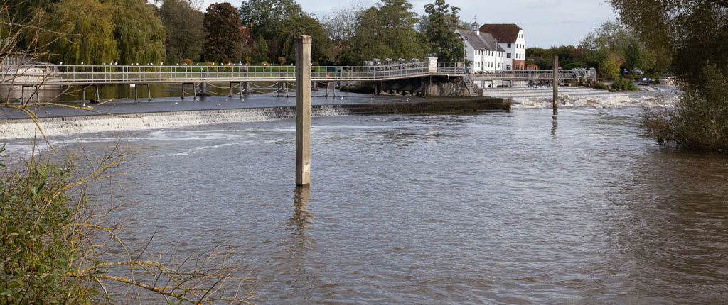 Hambleden Weir in Berkshire with Hambleden Mill in the right of centre background.