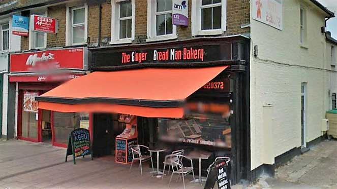 Two shops, the nearest, a bakery has a service entrance on the right hand side.