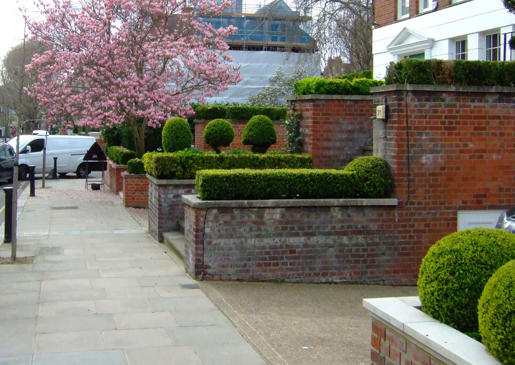 facing west in Melbury Road, W8, with the corner being Abbotsbury Road.