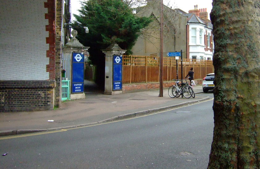 Looking onto Prebend Gardens with the entrance gate to Stamford Brook station to the left.