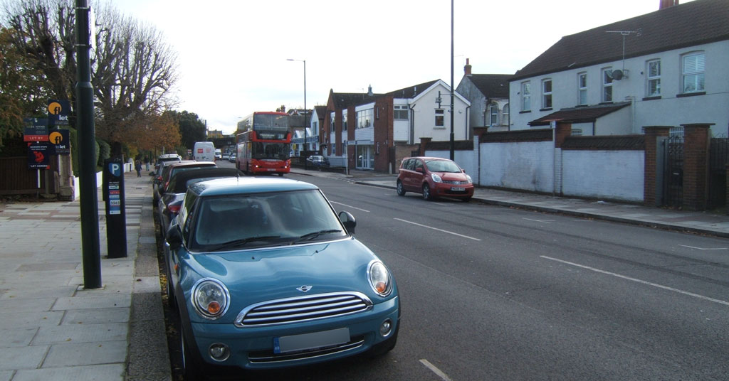 Facing south between Woffington Close and Warwick Road on Upper Teddington Road in Kingston upon Thames.