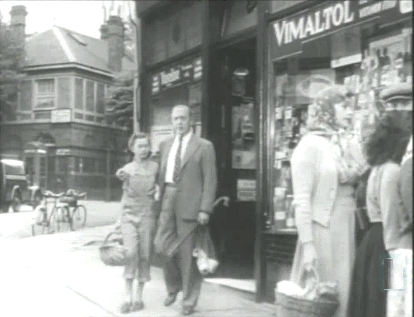 The corner of Belsize Lane and Belsize Terrace with Belsize Place in the left background. Circa 1951