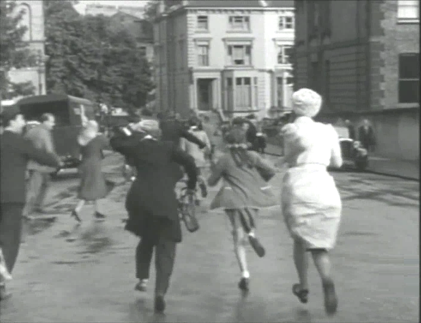 Belsize Terrace with the junction of Belsize Avenue, Belsize Park Gardens and Belsize Park ahead. Circa 1951
