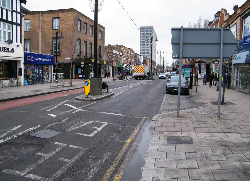 An High Street view with a tall block of offices at the end.