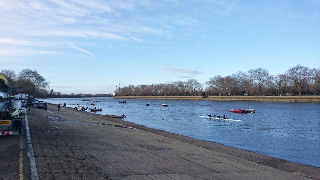 The River Thames at Putney with Fulham Football Ground in the right of centre distance.