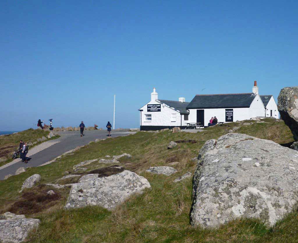 A white painted single storey building on a cliff side setting.