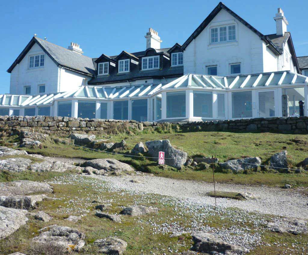 The coastal side of a clifftop hotel with a large conservatory.