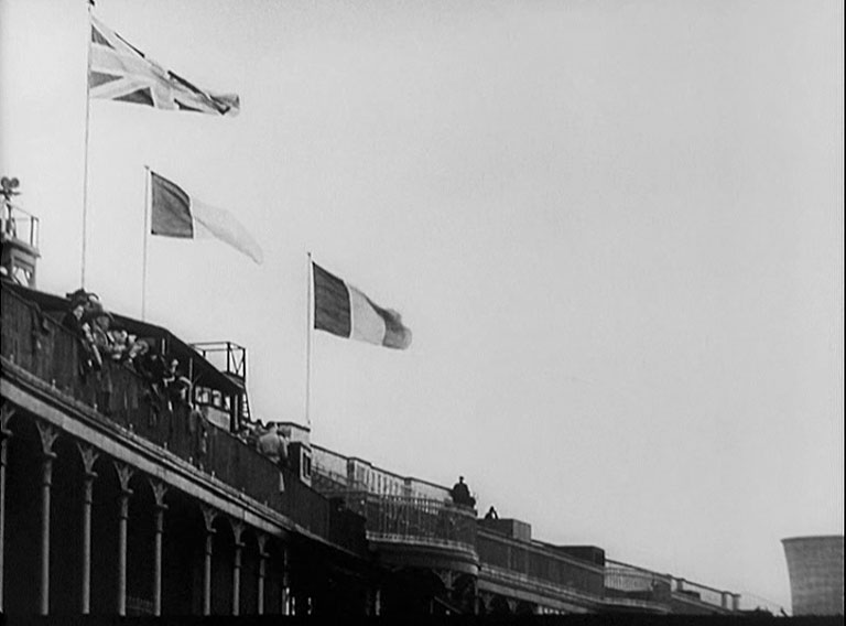 Three flags aloft the top part of the Aintree grandstand