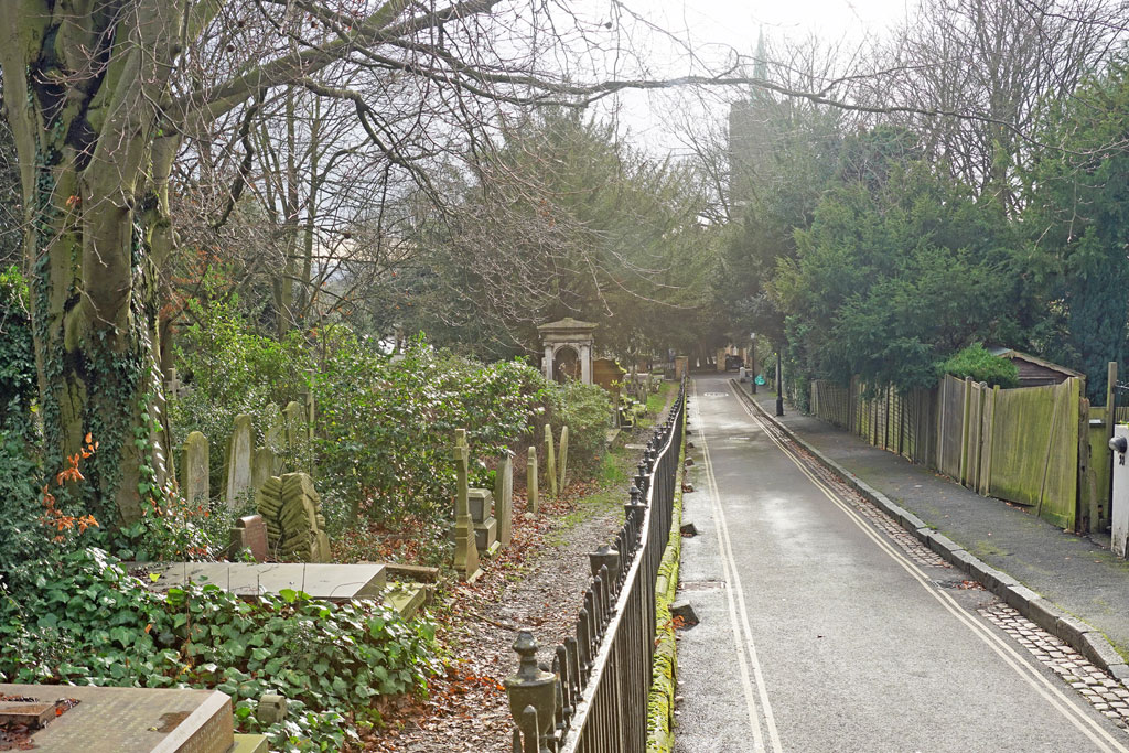 Looking south along Holly Walk in Hampstead, London NW3 with the tower of Hampstead Parish Church in the top distance.