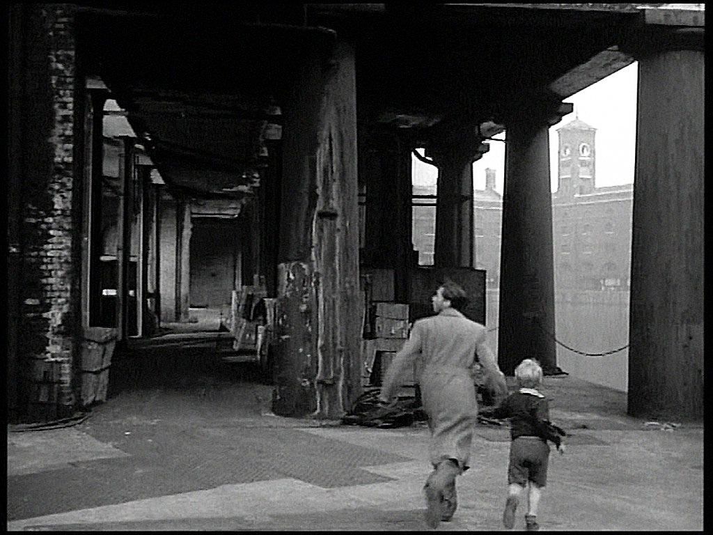 St. Katharine Docks, Ivory House is visible between the pillars. Circa 1952