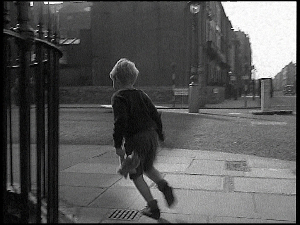Robbie (Jon Whiteley) as he arrives on the pavement with his teddy bear and runs into Claverton Street. Circa 1962