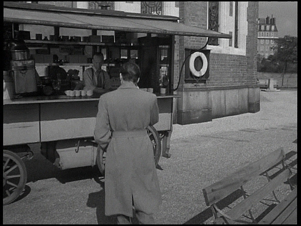 Behind the stall is the Rotherhithe Tunnel airshaft. Circa 1952
