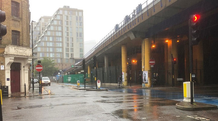 The corner of Cable Street and Dock Street in E1 with Royal Mint Street ahead, Leman Street to the right and the viaduct carrying the Docklands Light Railway overhead.