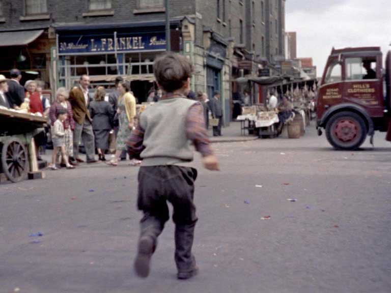 Looking north to Goulston Street at the crossroads with Wentworth Street. L. Frankel, butchers, 30 Wentworth Street, London E1 Circa 1955