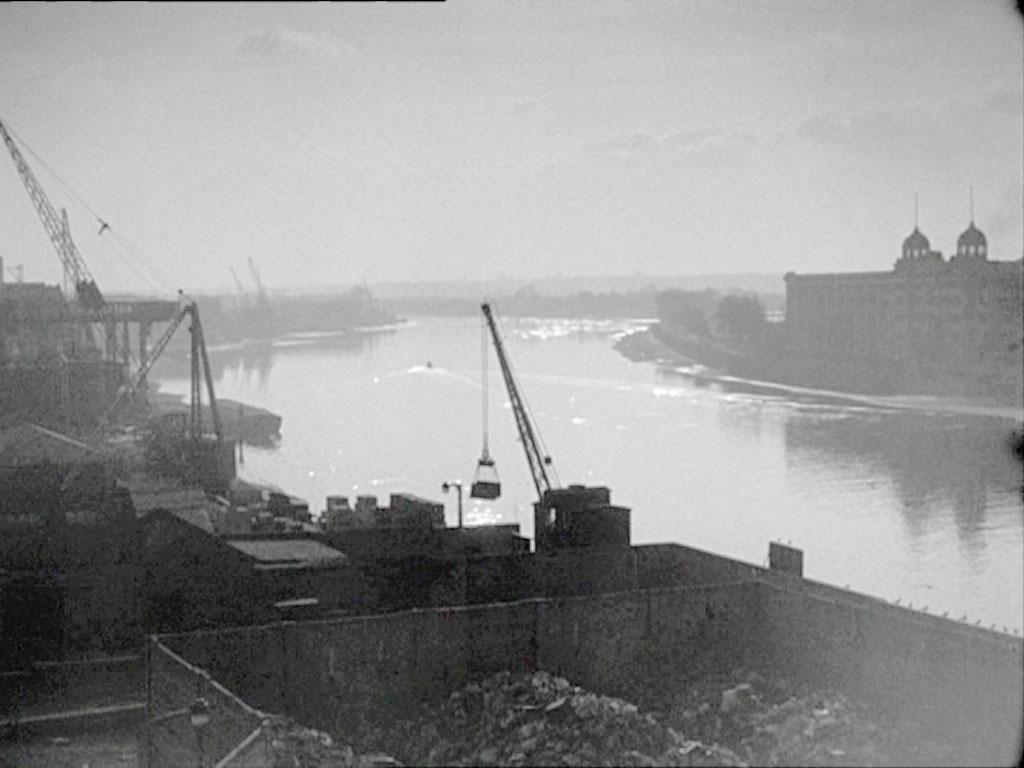 view up the Thames looking over Chancellors Wharf, Crisp Road/Chancellors Road, Hammersmith W6 towards the Harrods Depository with the two domed turrets to the right on the opposite side of the River Circa 1956