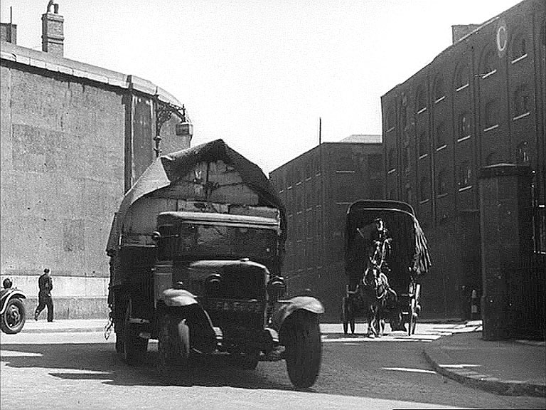 'C' Warehouse of St Katharine Docks with the wall of Royal Mint on the other side of East Smithfield. Circa 1942
