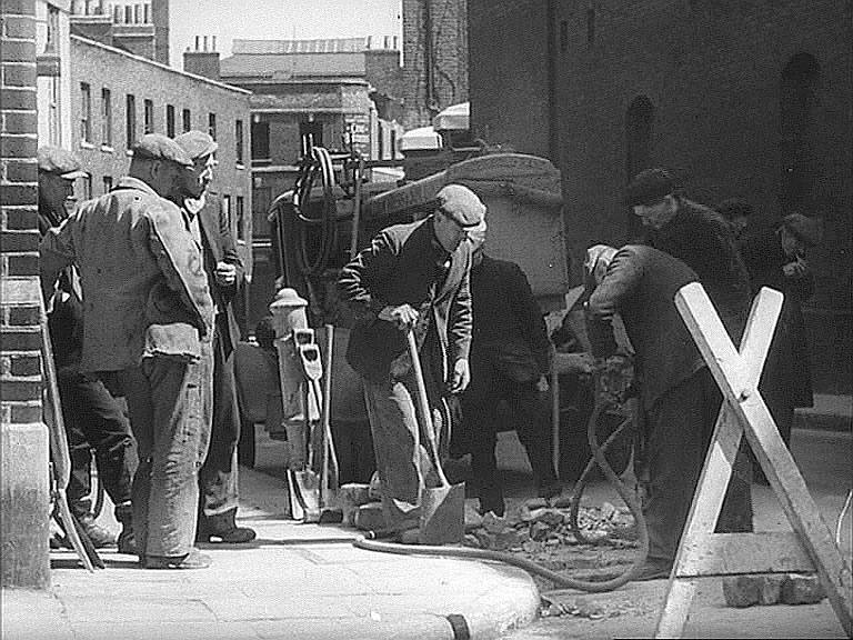 East Smithfield where it becomes The Highway, London E1, we are on the corner of Ensign Street and in the shadow of a London Docks warehouse looking east. Circa 1942