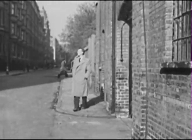 Looking north from Ridgmount Street WC1 across Chenies Street to the mansion block of Ridgmount Gardens. Circa 1949