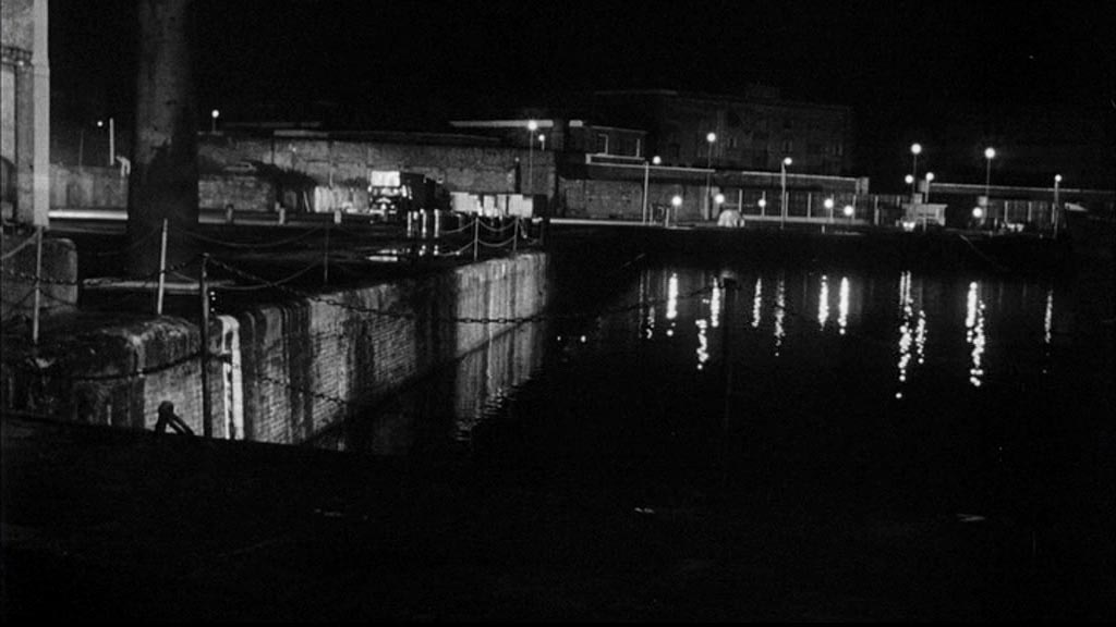 Looking across East Dock, St Katharine Docks, London E1, over Thomas More Street to the entrance to London Docks and associated warehouse(s). Circa 1965