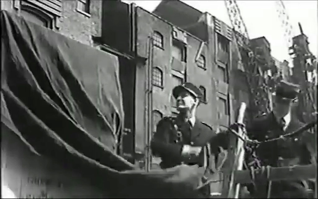 Irongate Wharf to the left and St Katharine Wharf behind the policemen Circa 1959