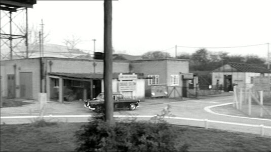 A collection of buildings and a water tower near the entrance of Pinewood Studios in Iver Heath, Buckinghamshire. Circa 1960