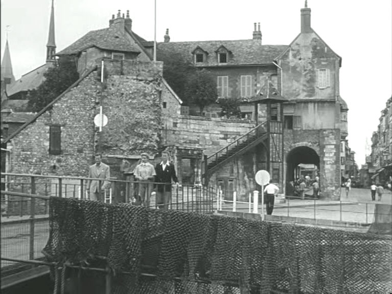 Quai de la Quarantaine looking north from the harbour with La Lieutenance, Quai Sainte-Catherine behind them. Circa 1954
