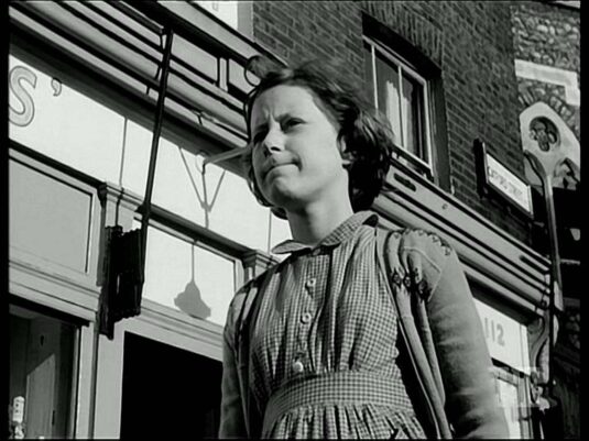 Outside 112 Horseferry Rd with much of the church bombed in 1944 still in tact. Circa 1958