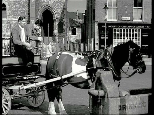 The bombed Church of the Sacred Heart, Horseferry Road and what is now ‘Cardinal Hume Charity Shop’ at 110. Circa 1958