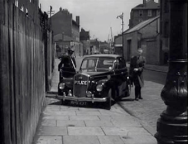 The Highway, E1, here looking east towards the junction with Butchers Row to the left and Narrow Street off to the right, followed by the appearance of Burrell House on the left hand side and Shipwright House opposite. Circa 1957