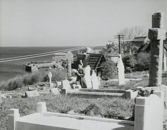 St Peter church, Coverack, cemetery looking back to the harbour. Circa 1949