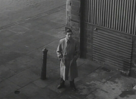 He has his back to the ruin of 401 The Highway. Circa 1949