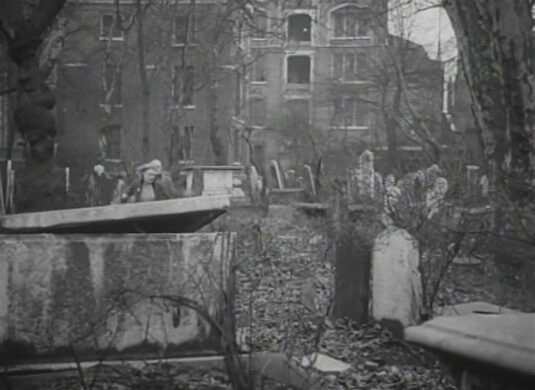 The disused graveyard of St. John of Wapping church in Scandrett Street, E1. Oliver’s Wharf in the background Circa 1949