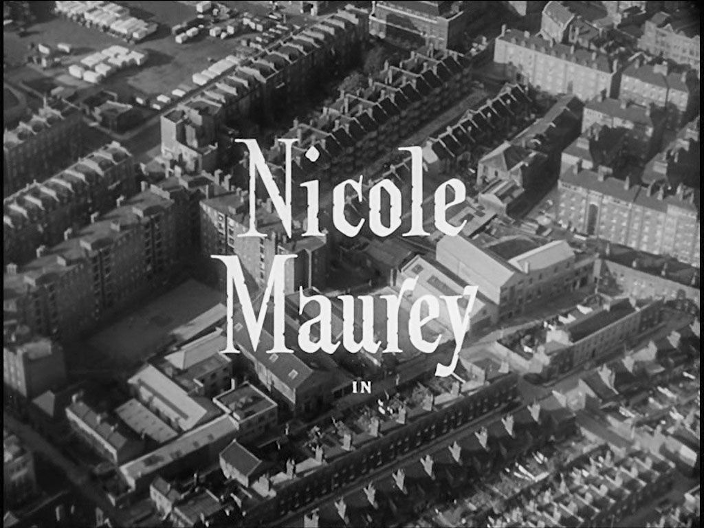 Aerial view of London. Stamford Street emerges from the left hand side, to leave the capture top center, to the right of which is a white banded school building, currently known as The London Nautical School. To the right of ‘Nicole’ is the Duchy Street Peabody Estate, SE1. Circa 1956