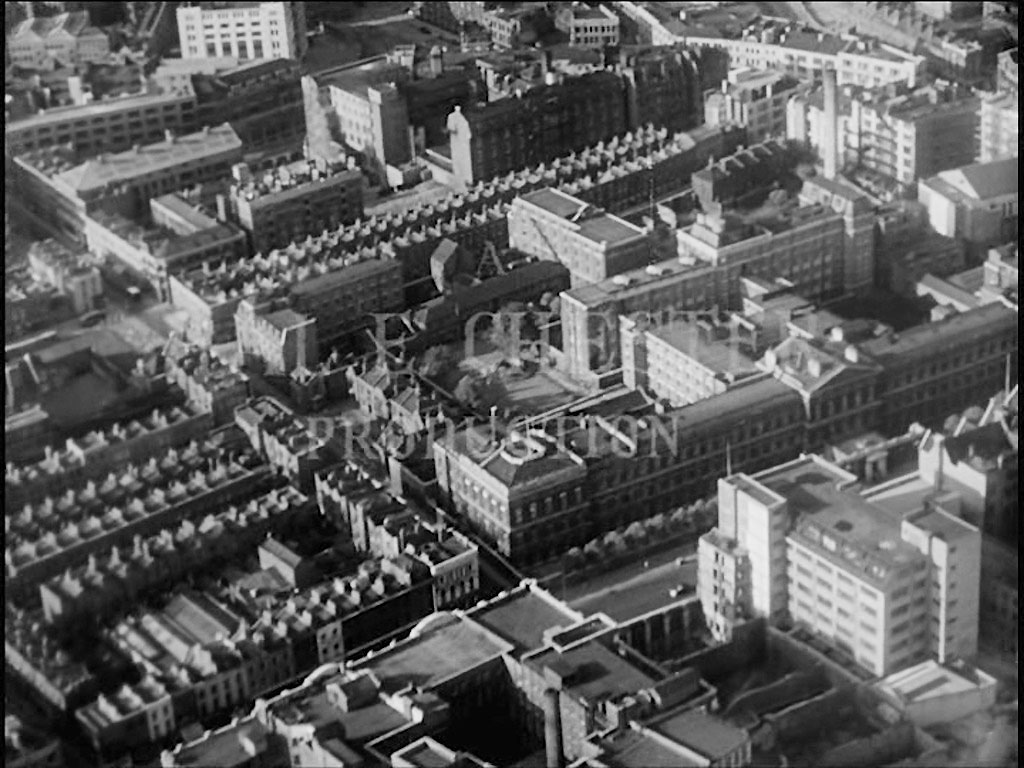 Aerial view of London. The fading ‘……..TION’ of ‘PRODUCTION’ highlights what was the ‘St Luke’s Printing Works’ in Old Street, EC1 Circa 1956
