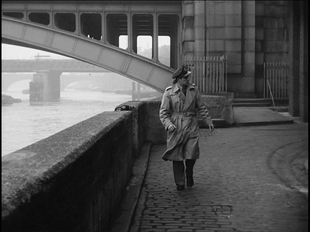 The south side of Southwark Bridge, Bankside with the piers of Blackfriars Railway Bridge followed by the arches of London Bridge visible through the foreground arch. Circa 1956