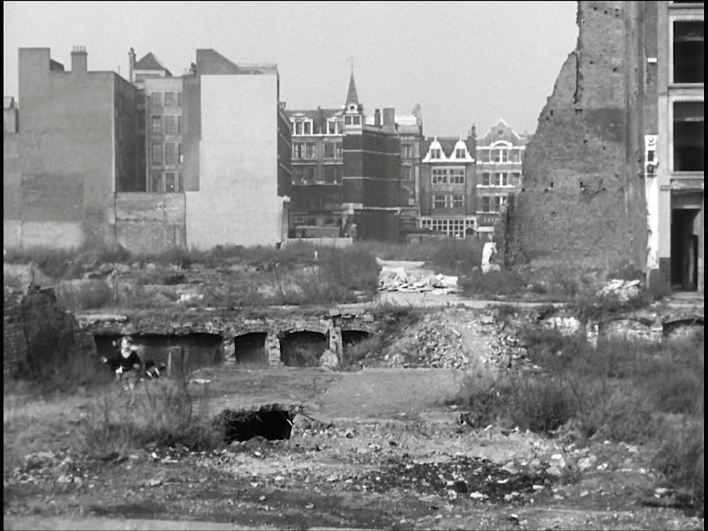 The properties in the far background are 51-58 Barbican, EC2. The Dutch gables are of W. Bryer & Sons, the frieze between its first and second floors were salvaged and have been incorporated into the Barbican development. Circa 1956