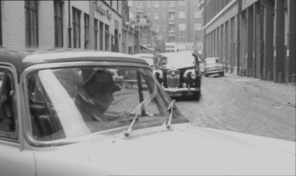 Redan Place, London W2 looking east towards the shops in Queensway and apartment block Inver Court in the background. Circa 1961