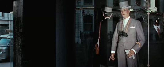 The corner of King Street and Garrick Street, WC2 in the reflection Circa 1966