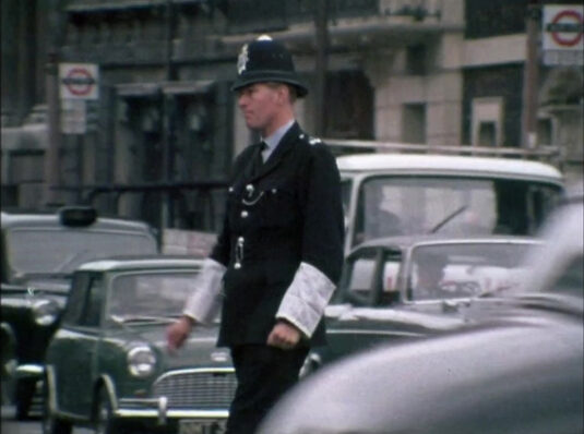 1 Derby Gate, SW1 starts to appear left of the left hand bus stop. Circa 1968