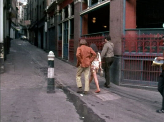 Passing The Walrus and The Carpenter public house they are about to enter Lovat Lane. Circa 1968