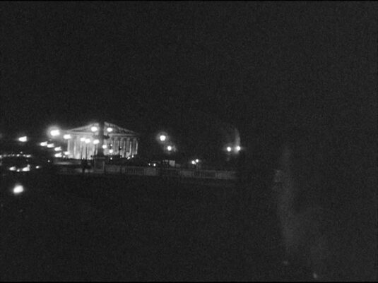 From the Place de la Concorde looking across Pont de la Concorde to the Palais Bourbon at night circa 1960
