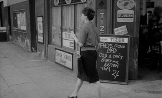 St. Luke's Road passing 'Freds Cafe' on the corner with Tavistock Crescent. Circa 1962